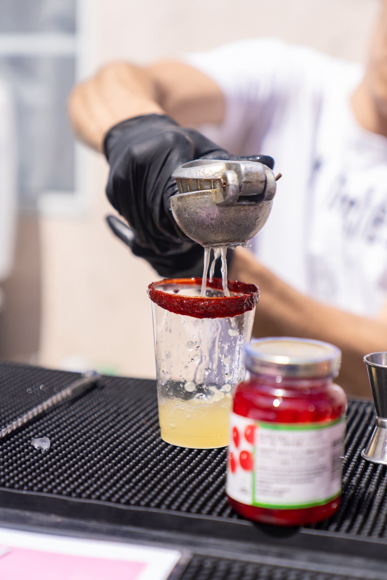 Rimdrip bartender straining a fresh cocktail at an event