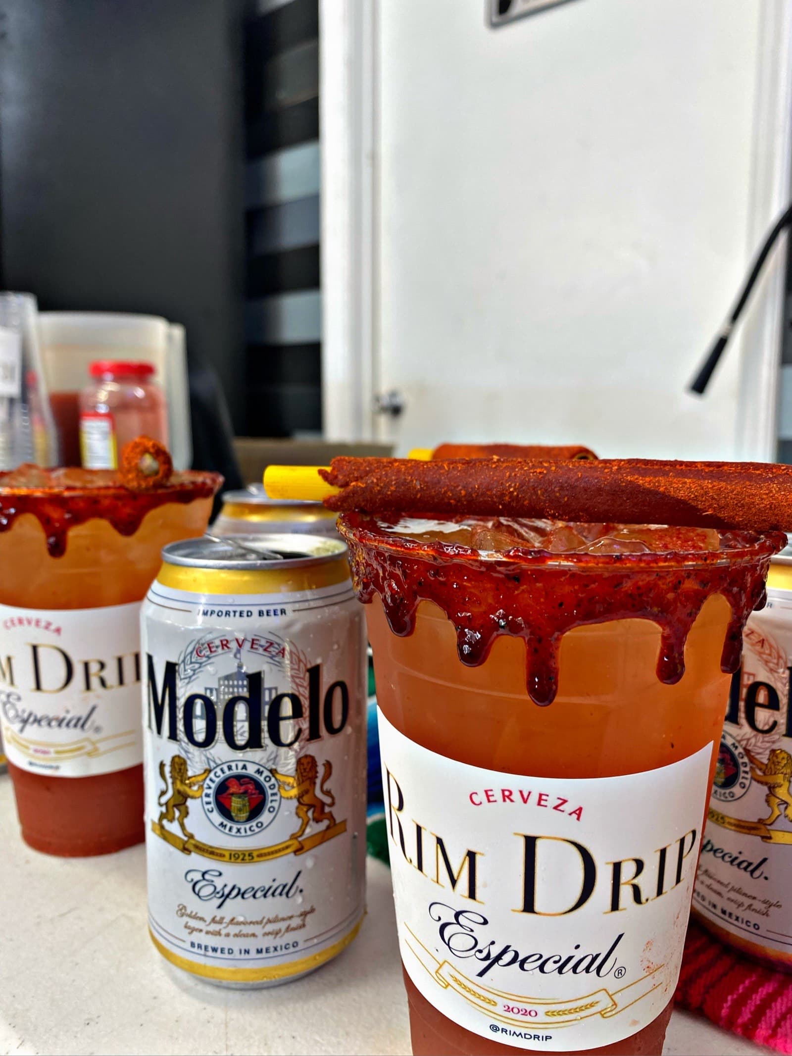 Lineup of strawberry micheladas with chamoy rim ready for guests
