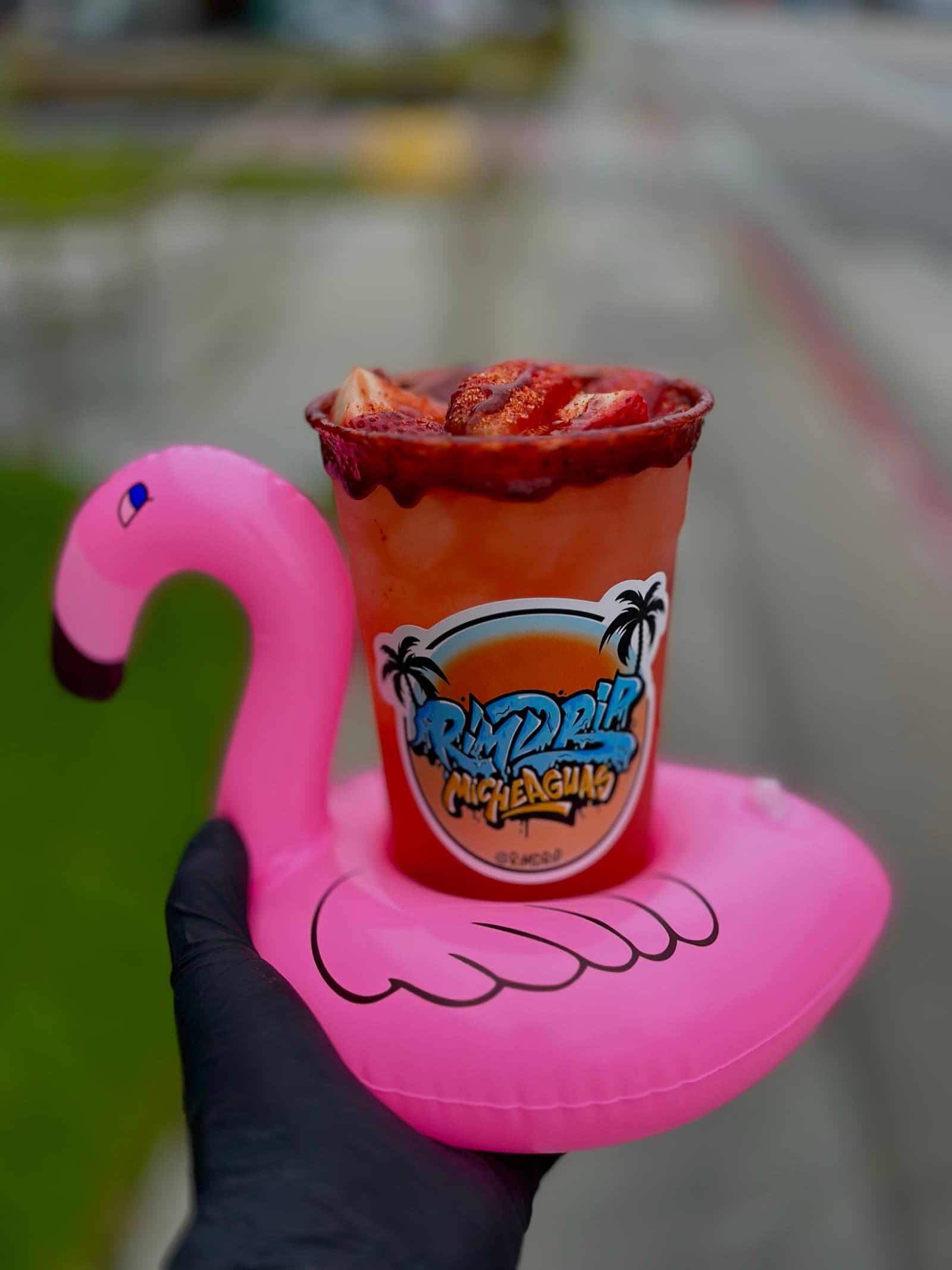 Strawberry michelada on a flamingo pool float — Rimdrip pool party