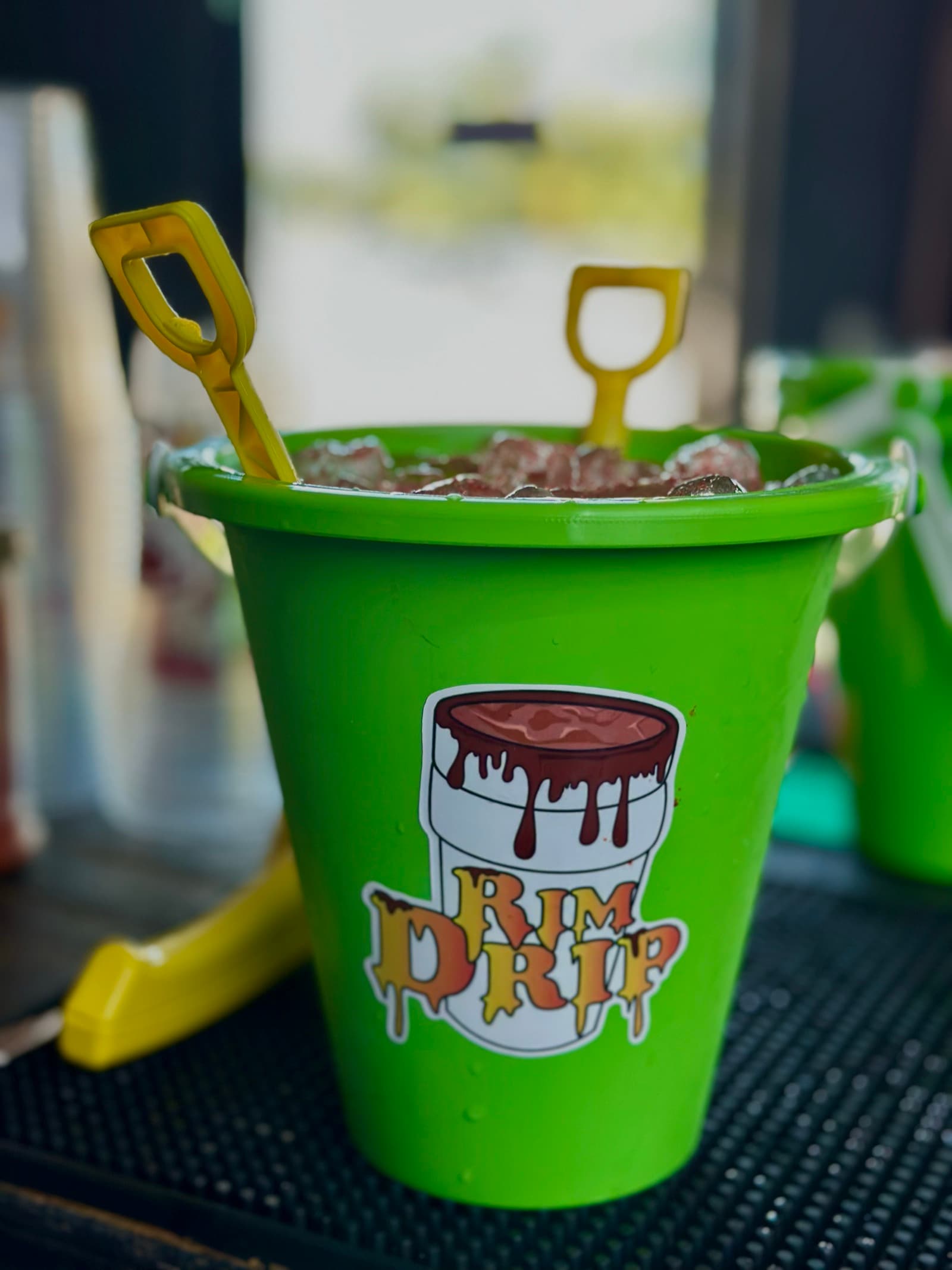 Rim Drip green bucket setup with shovels for a custom event